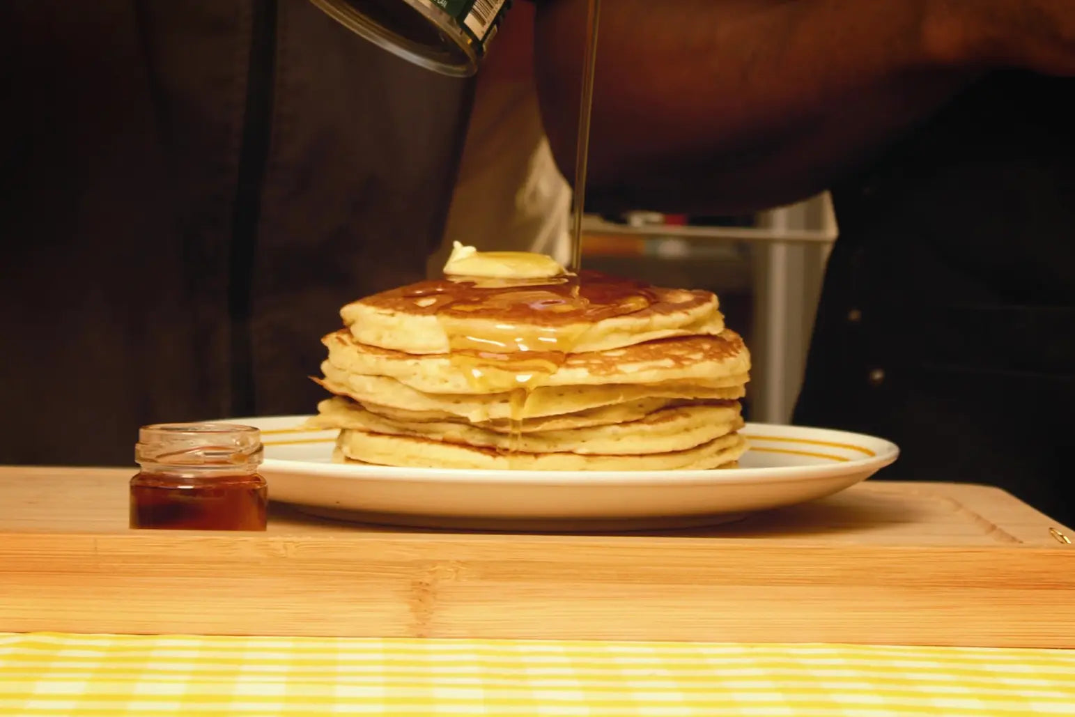 Syrup being poured onto Happyfield pancakes prepared by Chris Theodosi & Jesse Orleans

